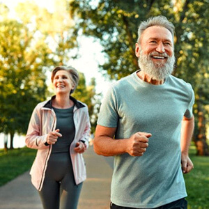healthy older couple jogging outdoors